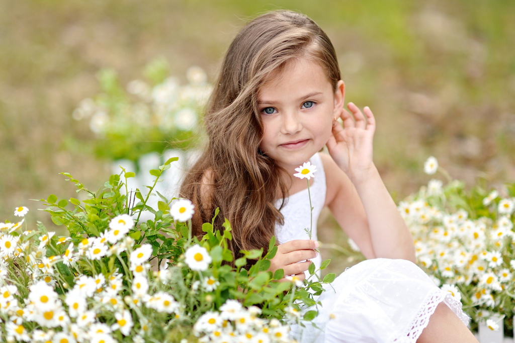 portrait of a beautiful little girl with flowers.